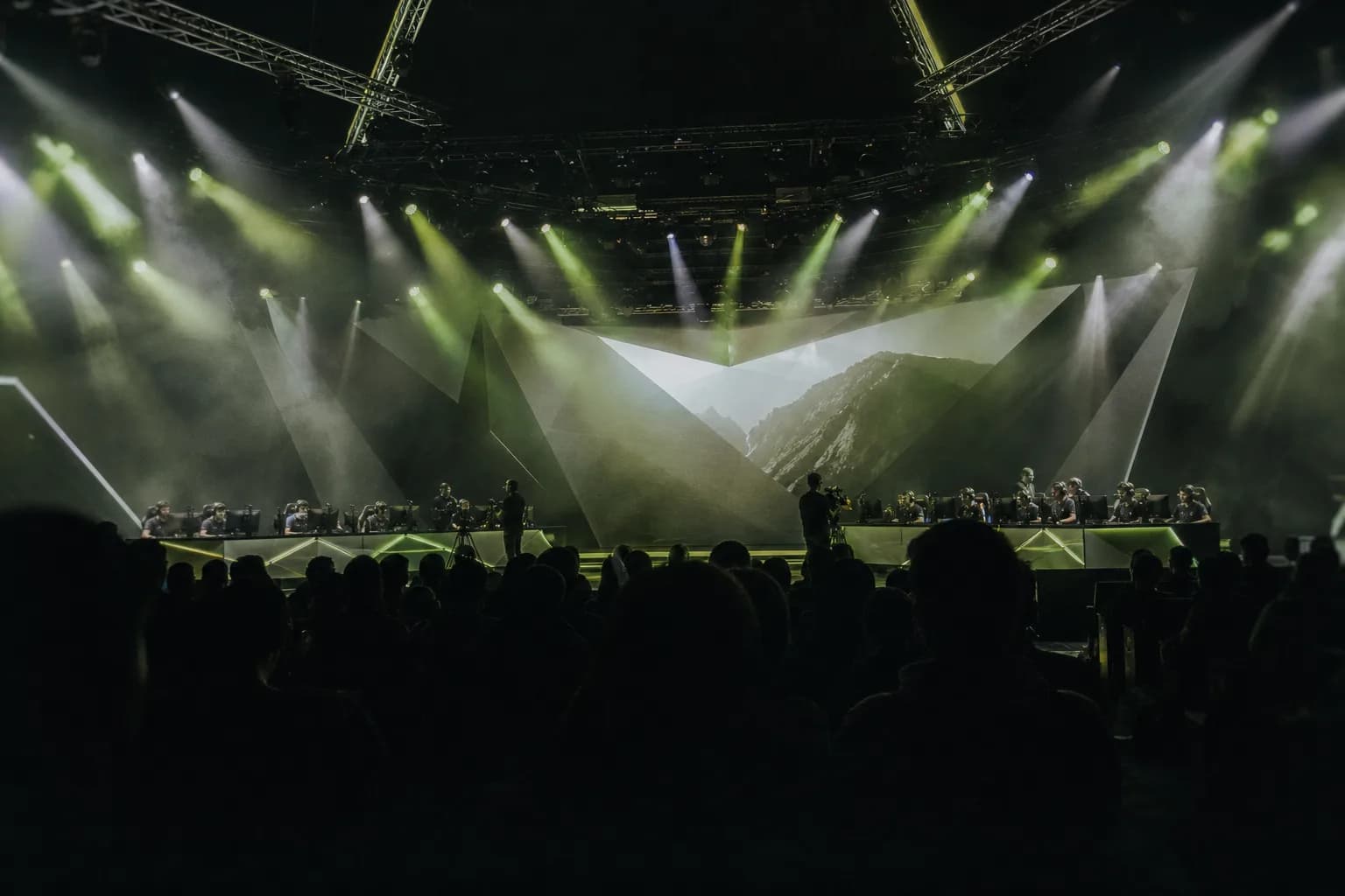 An imagined esports arena under sage and lime spotlights